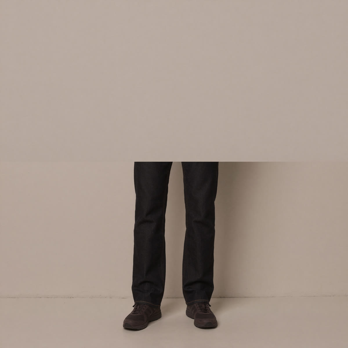 slim-sneakers-tapered-denim - The Tall Take Lower body view of dark tapered denim over slim low-profile sneakers