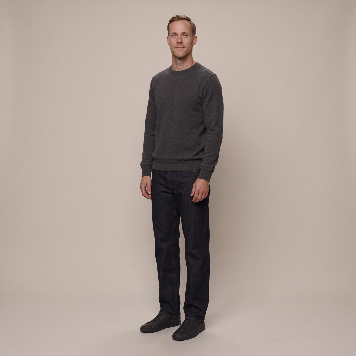 tall-men-slim-sneakers-full-look - The Tall Take A tall man in a charcoal sweater and dark denim wearing slim low-profile sneakers